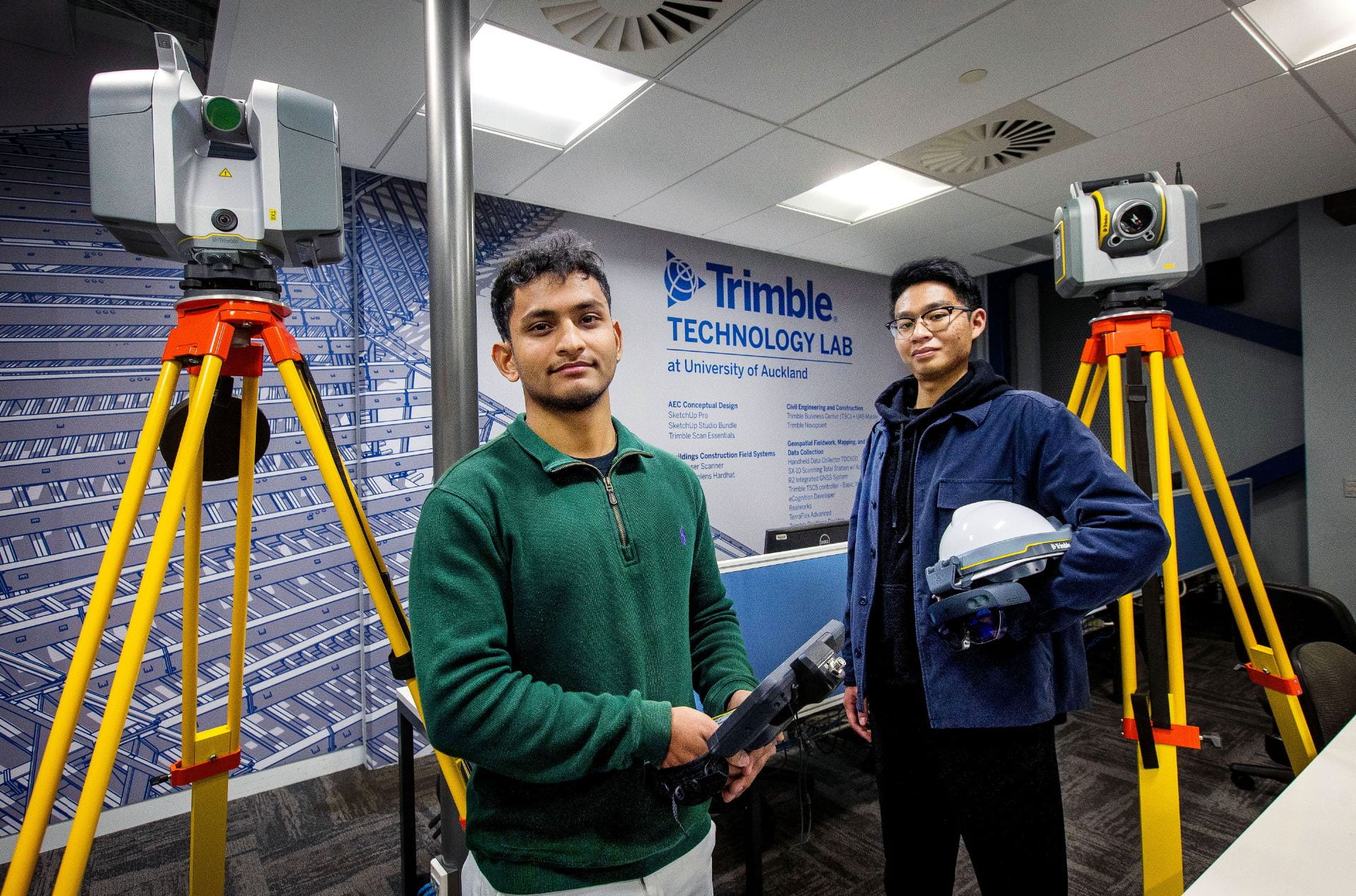Another picture of two students amongst Trimble Technology, inside the Trimble Technology Lab.