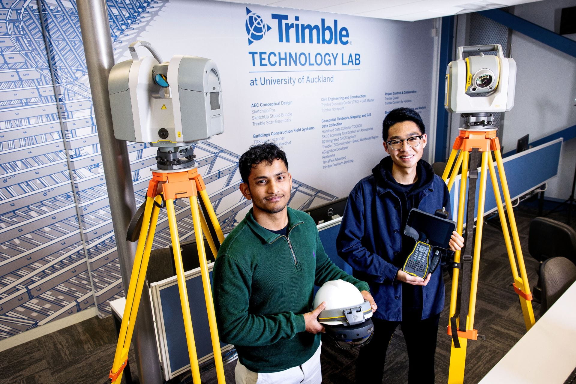 A picture of two students amongst Trimble Technology, inside the Trimble Technology Lab.